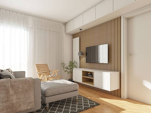 Stylish living room featuring custom-made furniture, a wall-mounted TV, and natural light for a comf.