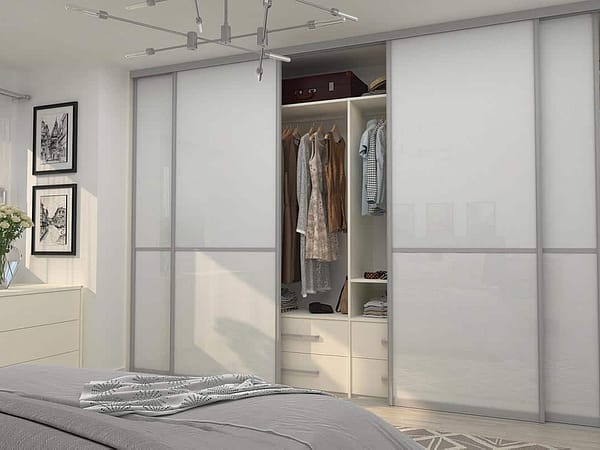 Built-in wardrobe with sliding doors for organized storage in bedroom.