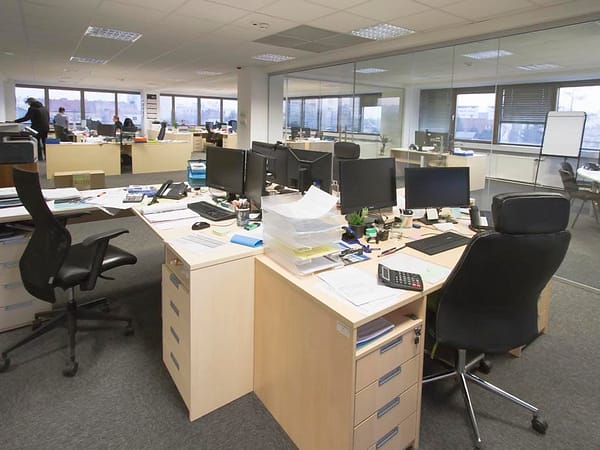 Office workspace with modern furniture and multiple desks.