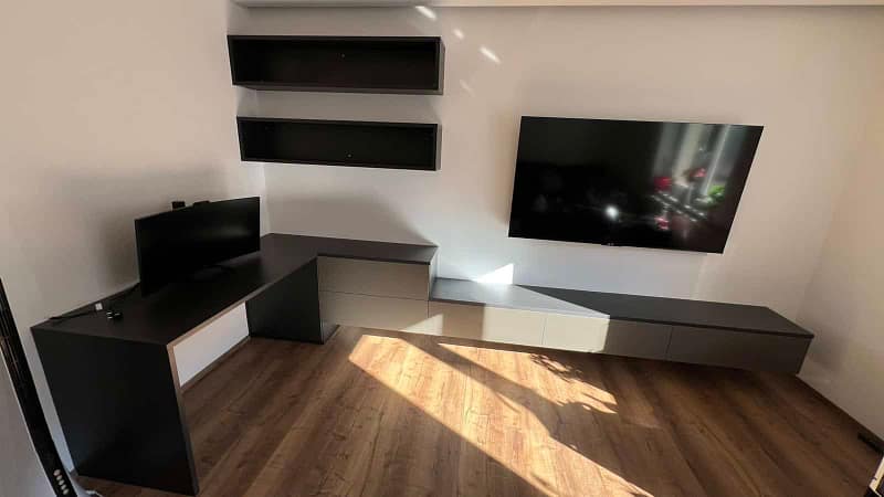 Custom-designed living room furniture with TV and storage solutions.