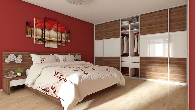 Built-in wardrobe with sliding doors and organized interior for bedroom storage.