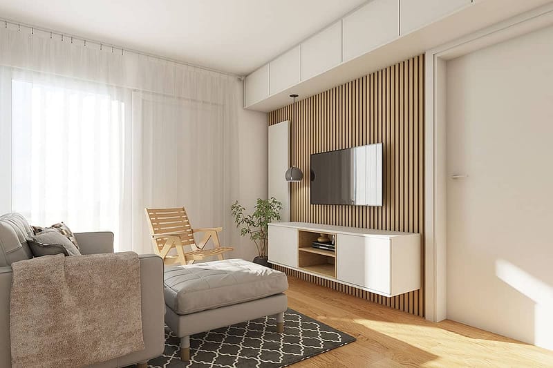 Stylish living room featuring custom-made furniture, a wall-mounted TV, and natural light for a comf.