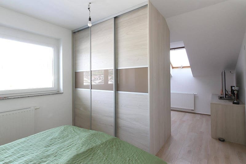 Built-in wardrobe with sliding doors for bedroom storage solutions.