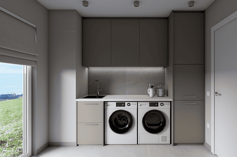 Modern and functional laundry room with built-in washing machine and cabinetry.