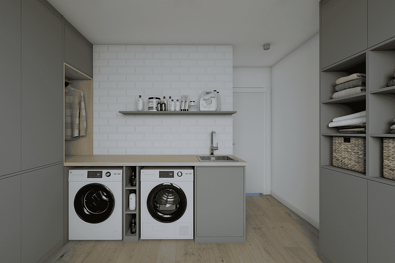 Efficient laundry area featuring tailored cabinets and modern washing machines.
