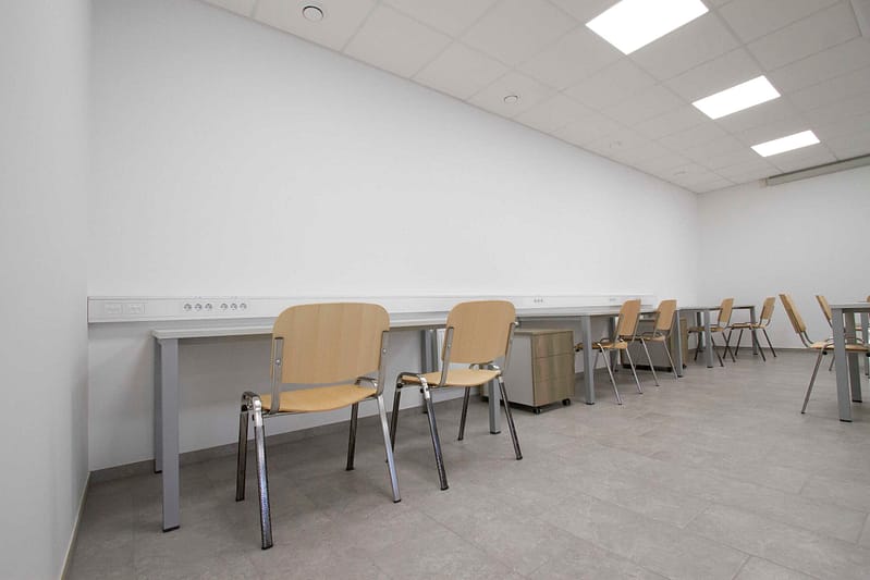 Office workspace with custom desks and chairs for business environments.