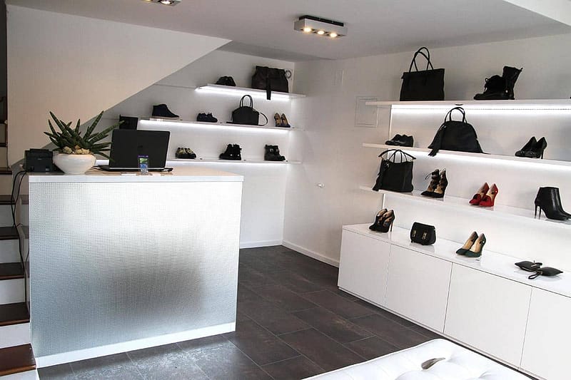 Office storage and display shelves with handbags and shoes.