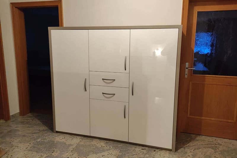 White wardrobe with storage space for shoes, coats, and accessories.