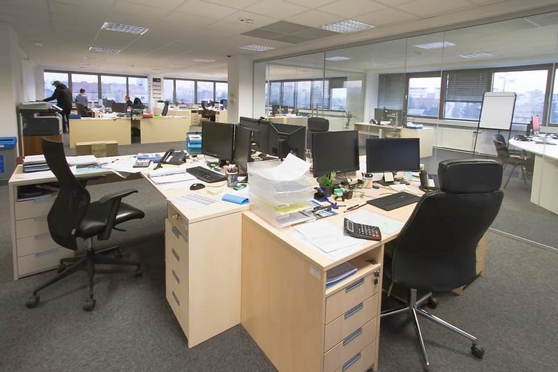 Office workspace with modern furniture and multiple desks.