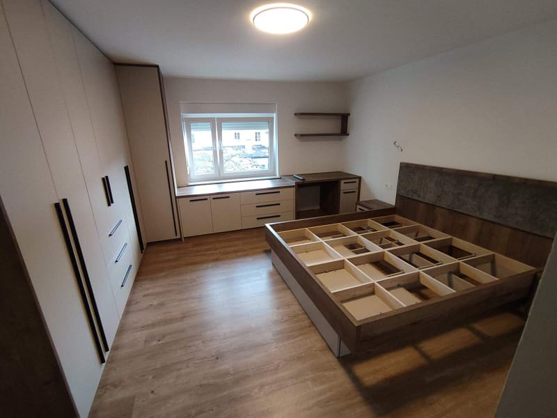 Custom bedroom furniture with integrated storage and minimalist design.