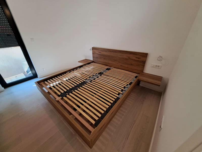 Wooden bed frame with headboard for bedroom comfort.